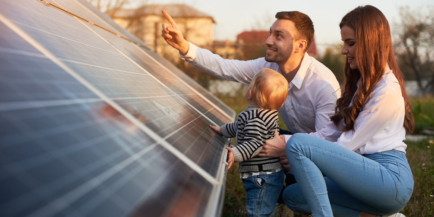 Family in front of a solar panel