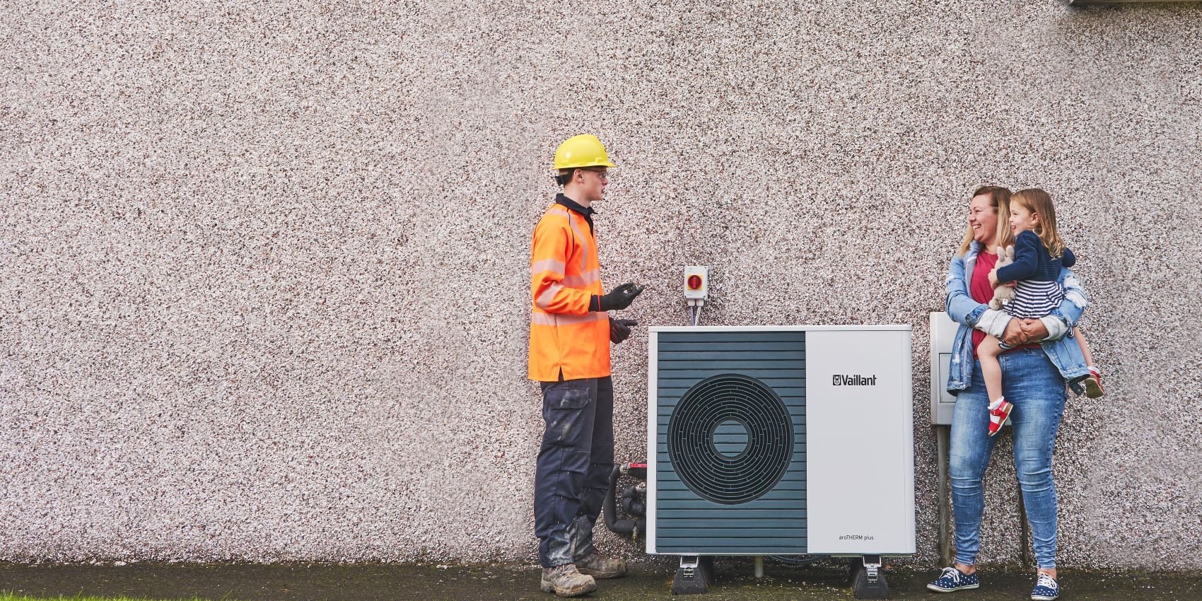 An SSEN engineer and customer examine a newly-installed heat pump