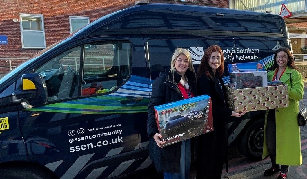 Three women with gifts at SSEN blue van