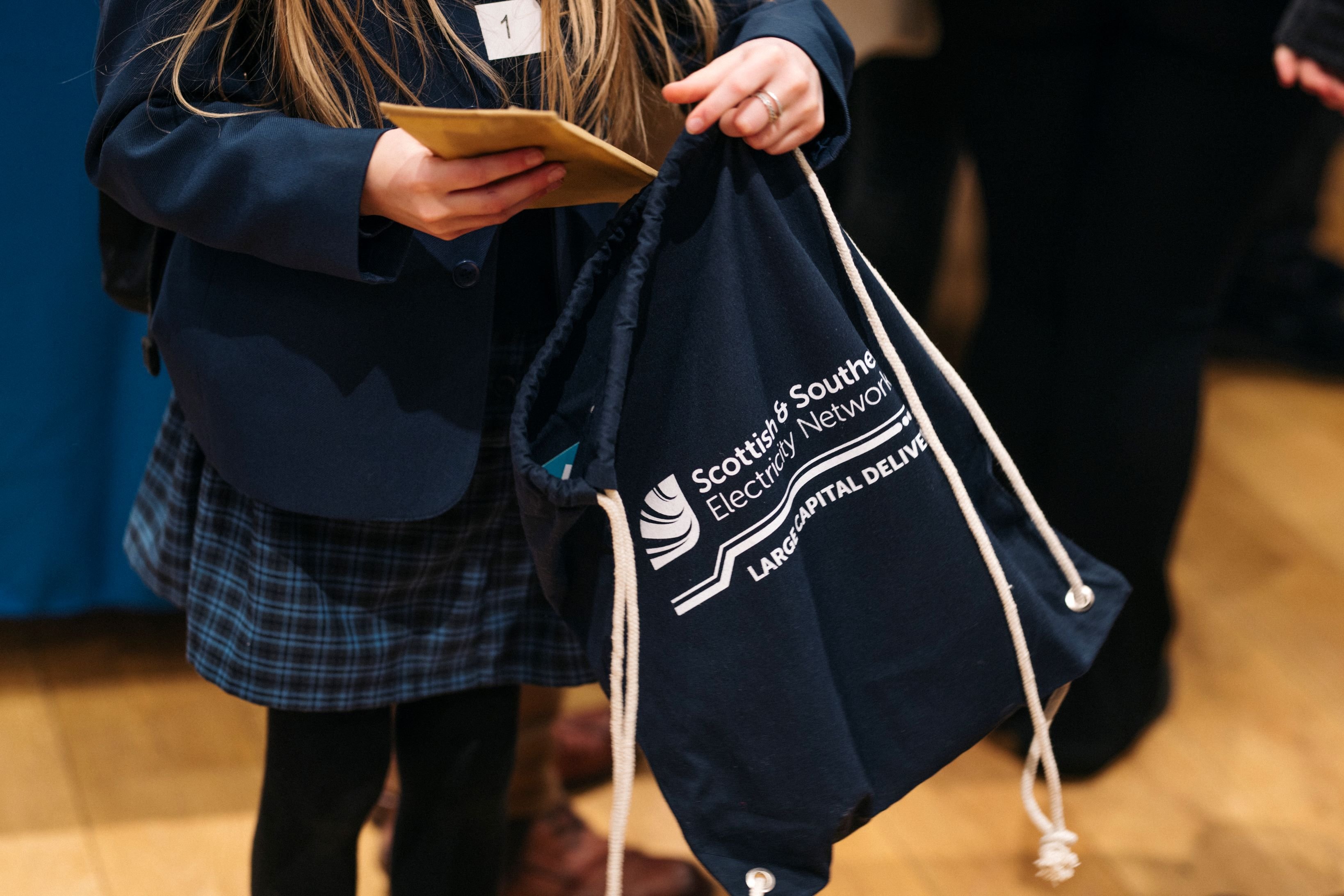 ssen large capital delivery goodie bag held by schoolgirl