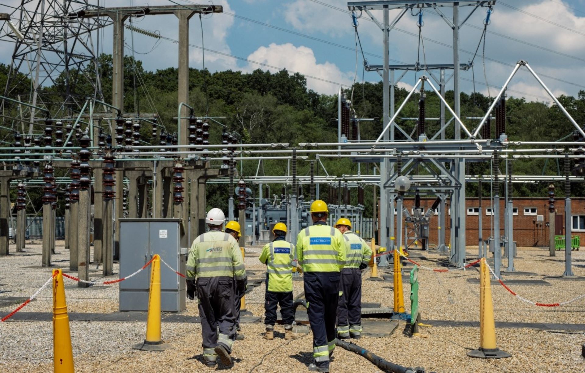 Engineers in high vis at substation