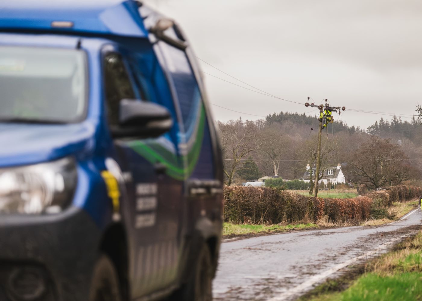 An SSEN vehicle drives past a fault being replaced on a country road