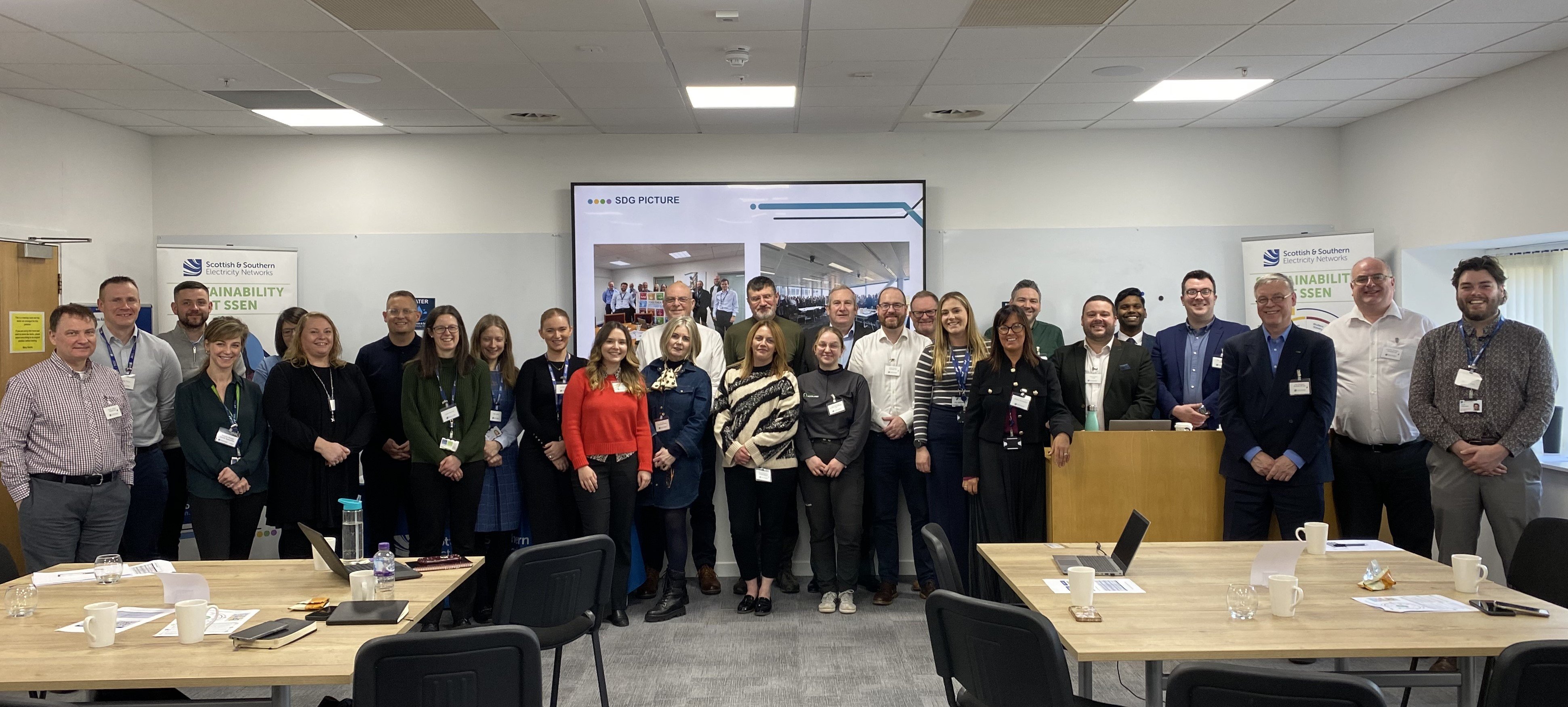 Group shot of men and women in office event room