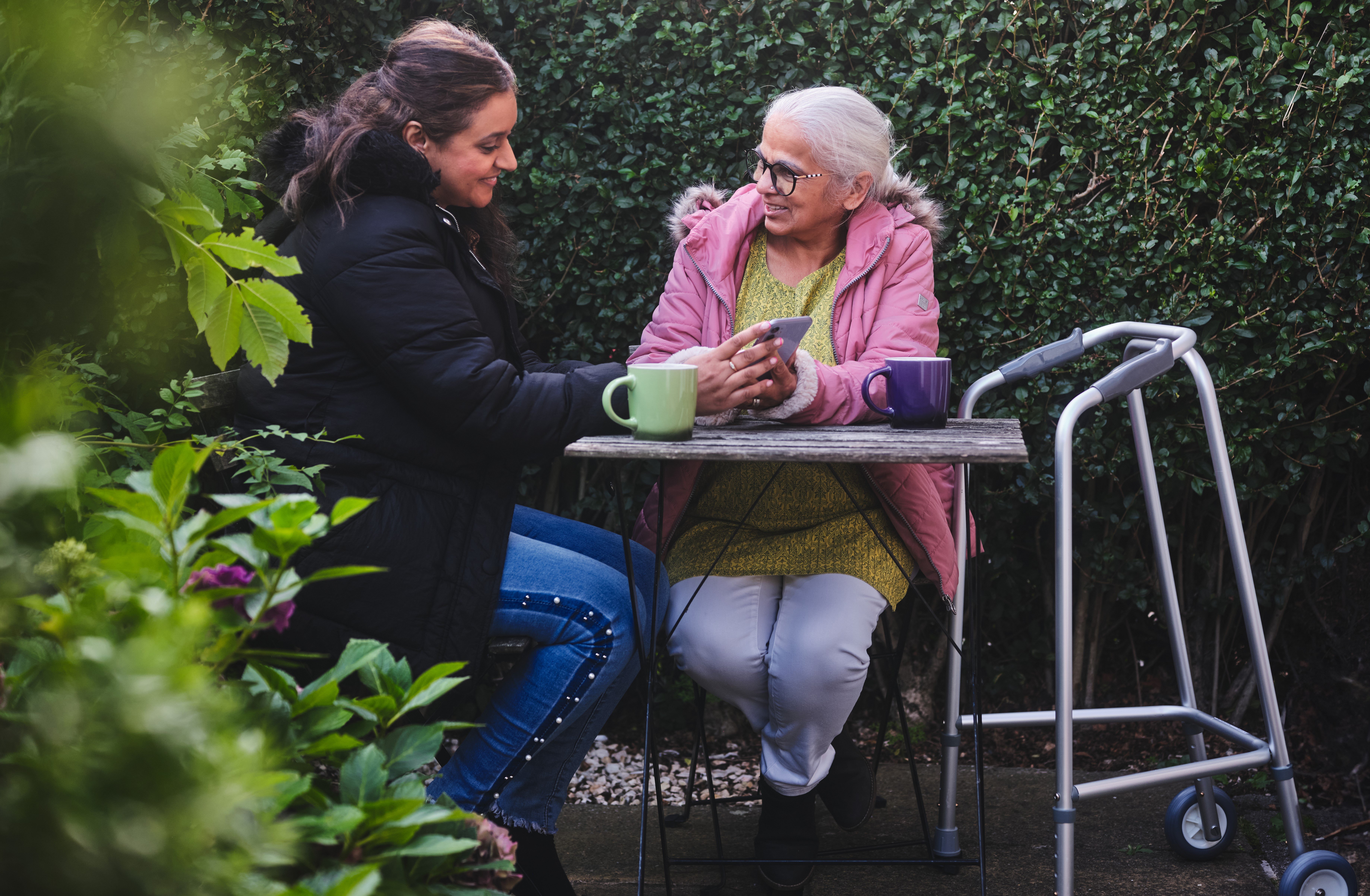 two women in garden with walking frame