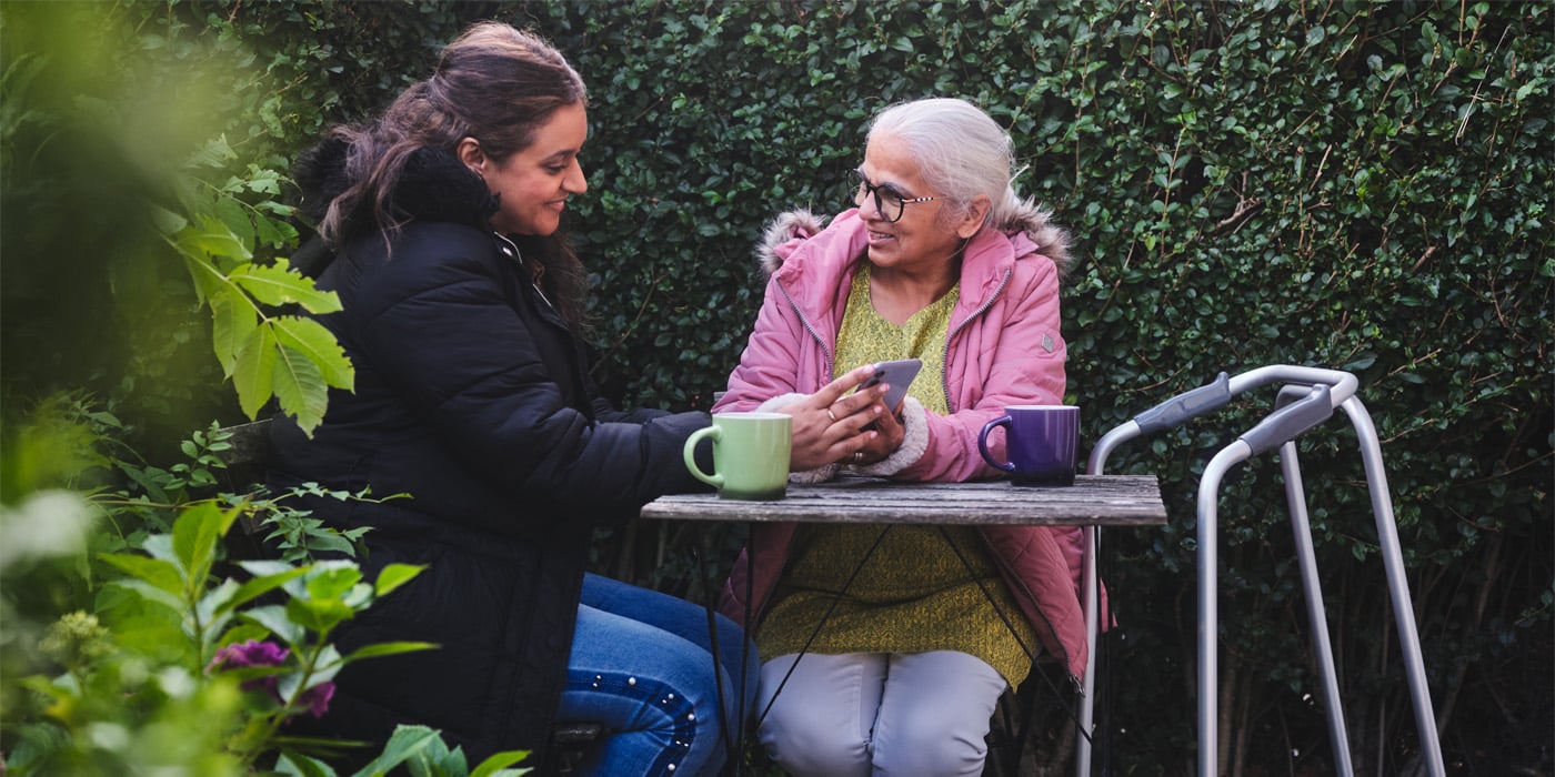 two women in garden with walking frame