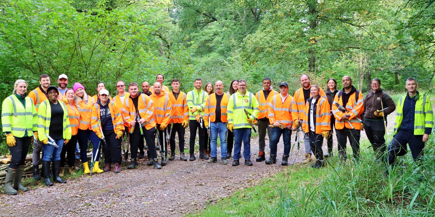 Group of people in woodland in high vis