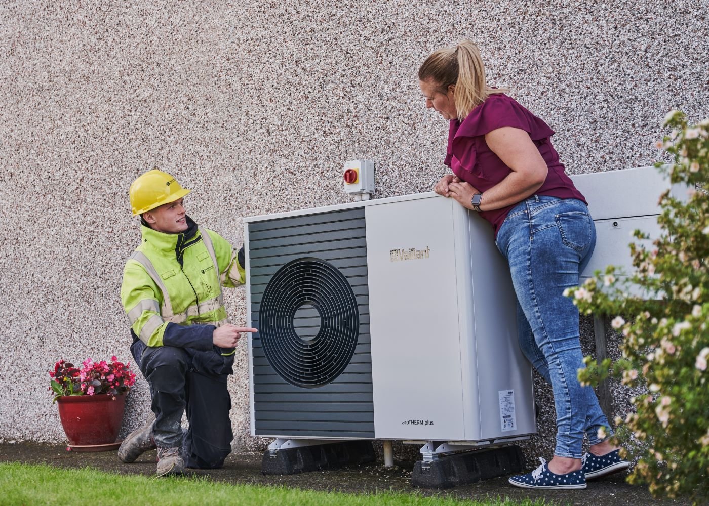 An SSEN engineer and customer examine a newly-installed heat pump