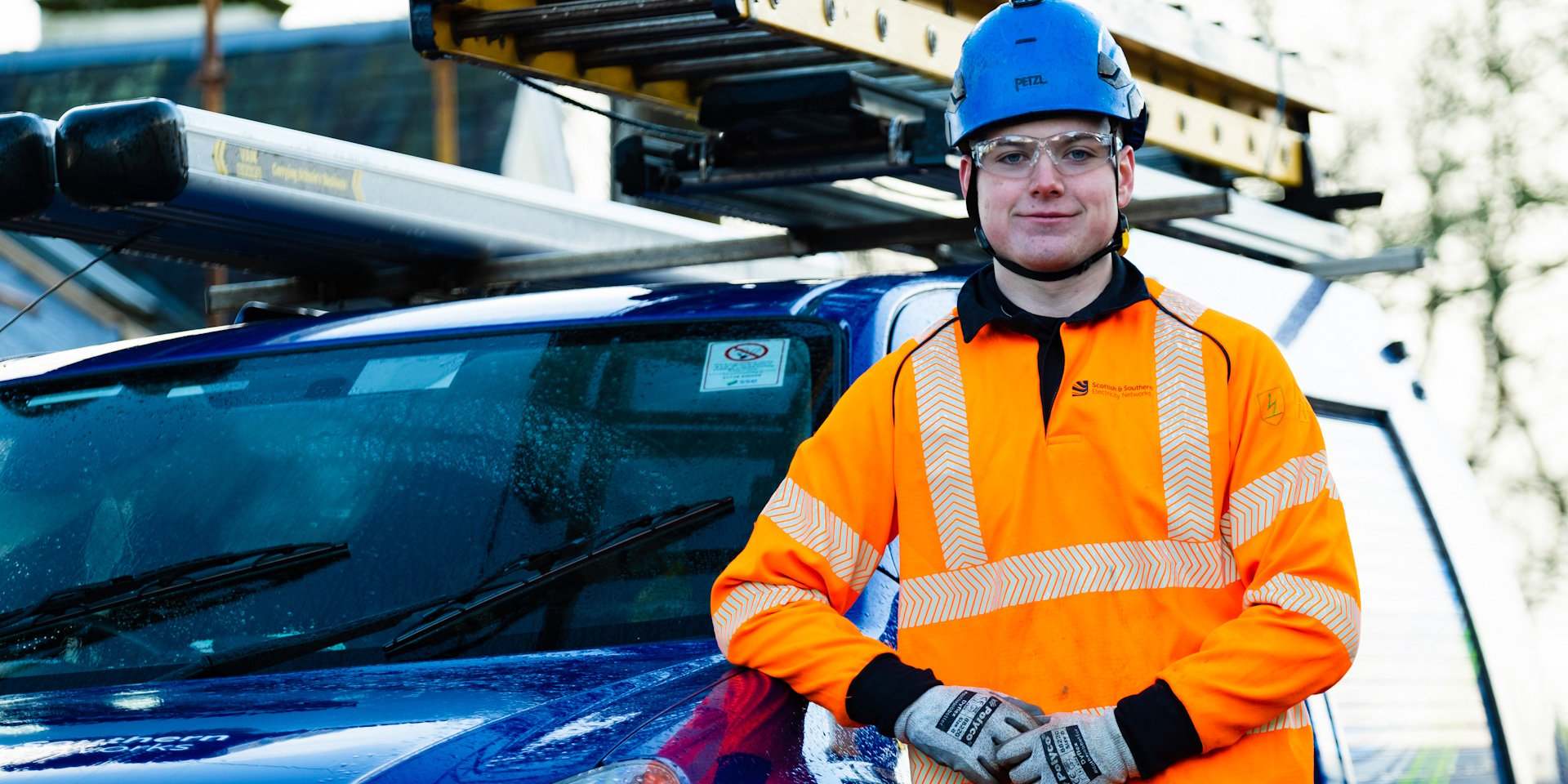 An SSEN apprentice by an operational vehicle 