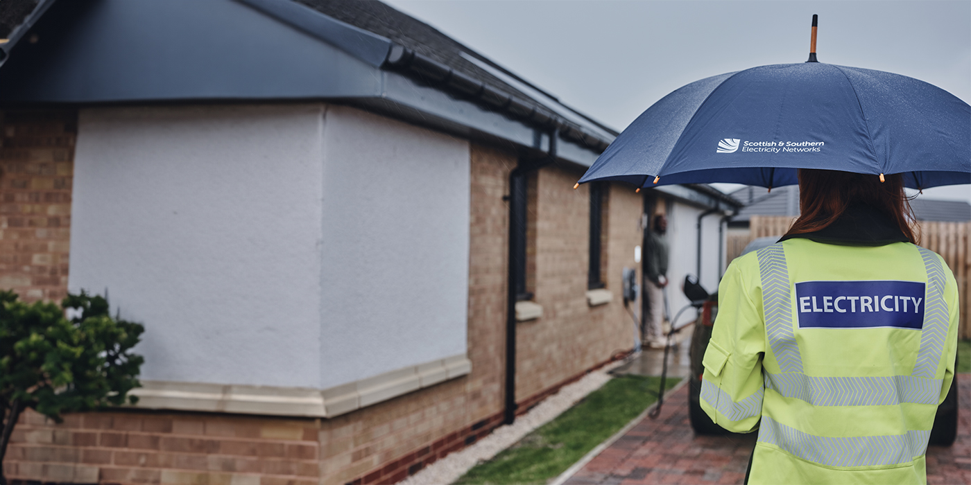 Engineer standing outside customers house 