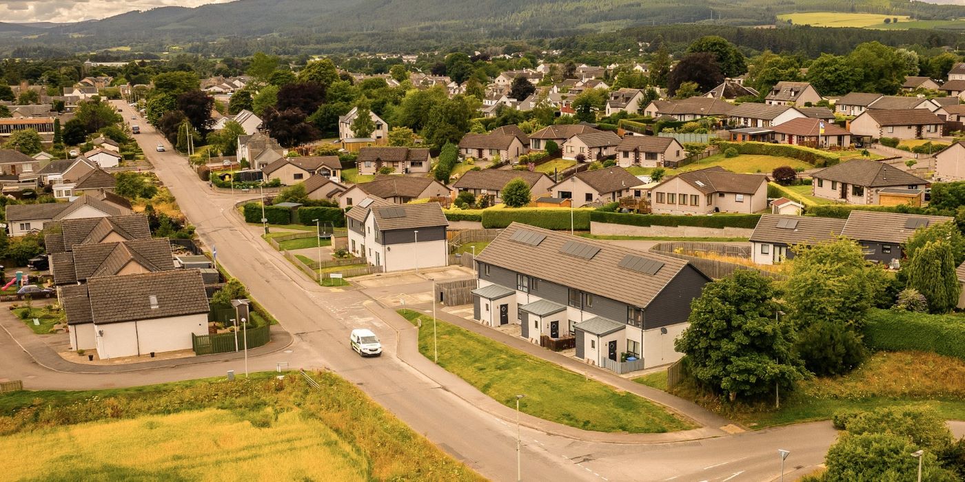 An aerial image of a small community showing houses with their own Distributed Energy Resources