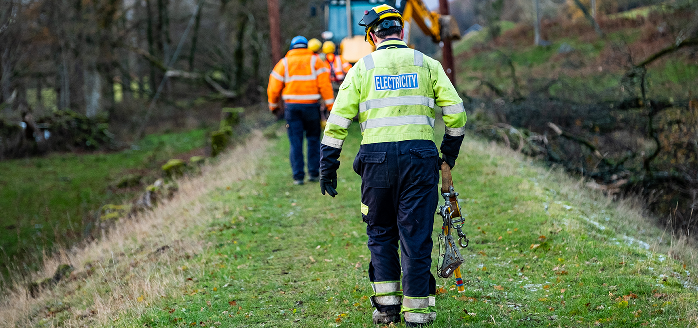 Image of SSEN engineer walking along forest path 