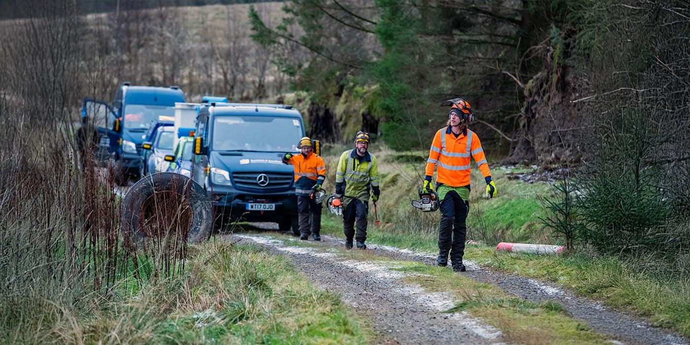 SSEN Engineers walking in front of vans in forest